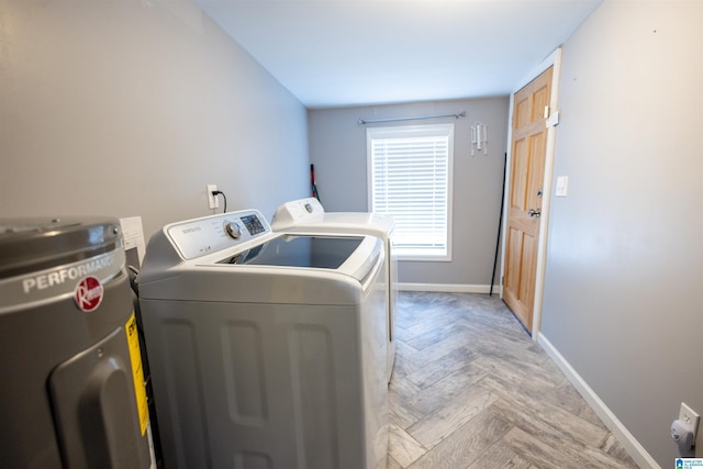 clothes washing area featuring separate washer and dryer and light parquet floors