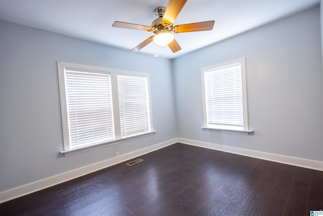 unfurnished room with ceiling fan and dark hardwood / wood-style floors