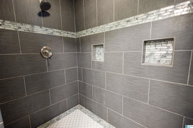 bathroom with tiled shower