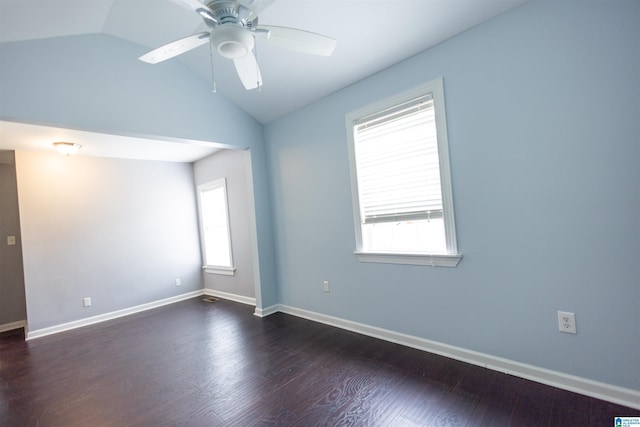 spare room with dark hardwood / wood-style flooring, vaulted ceiling, and ceiling fan