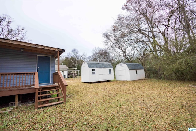 view of yard featuring a storage shed and a deck