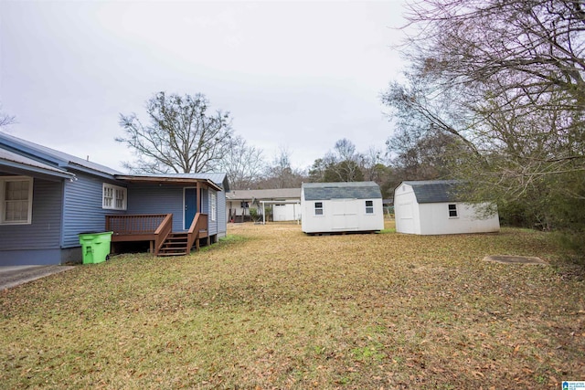 view of yard featuring a shed and a wooden deck