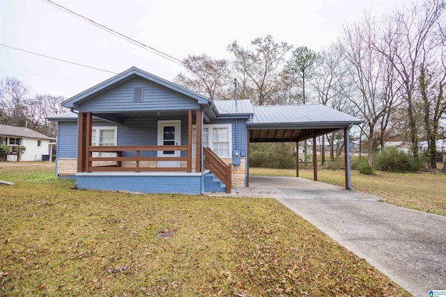 bungalow-style home featuring covered porch, a front lawn, and a carport