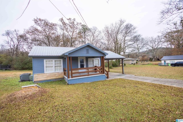 bungalow with covered porch, a carport, and a front yard