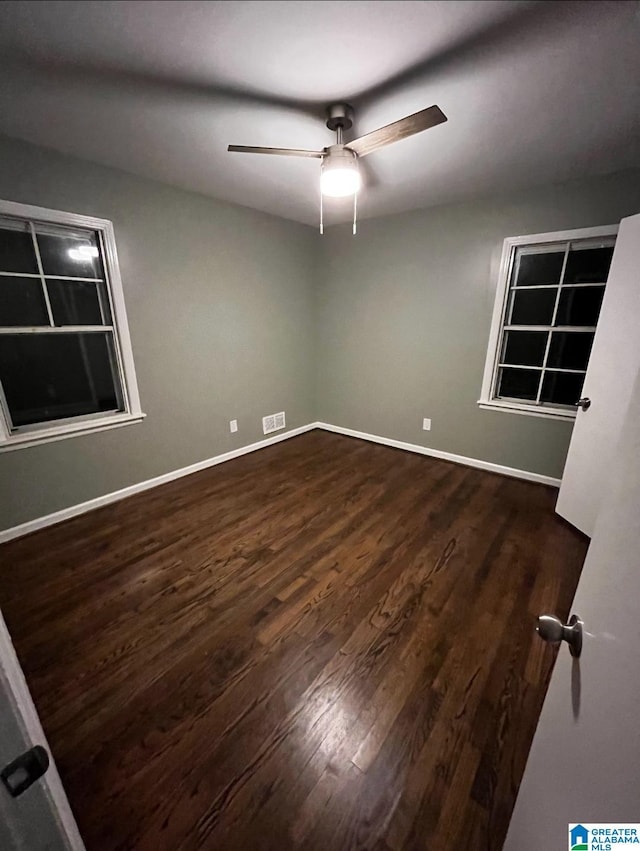 spare room featuring dark hardwood / wood-style floors and ceiling fan