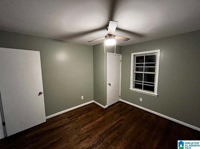 unfurnished room featuring ceiling fan and dark hardwood / wood-style flooring