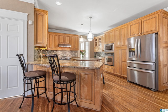 kitchen with decorative backsplash, ornamental molding, light stone counters, kitchen peninsula, and stainless steel appliances