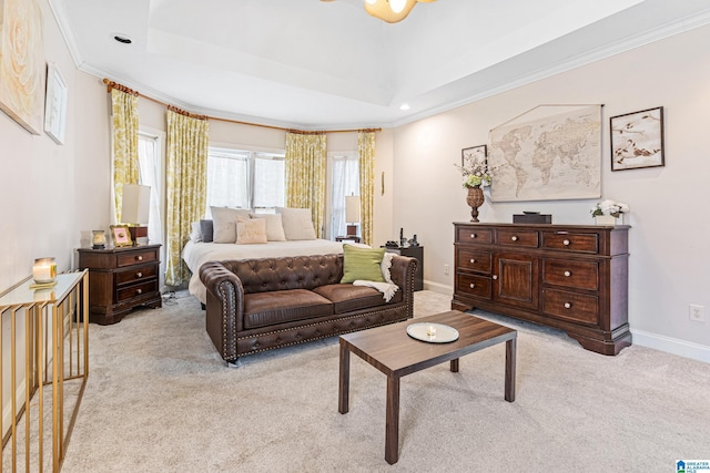 carpeted bedroom featuring a tray ceiling and crown molding