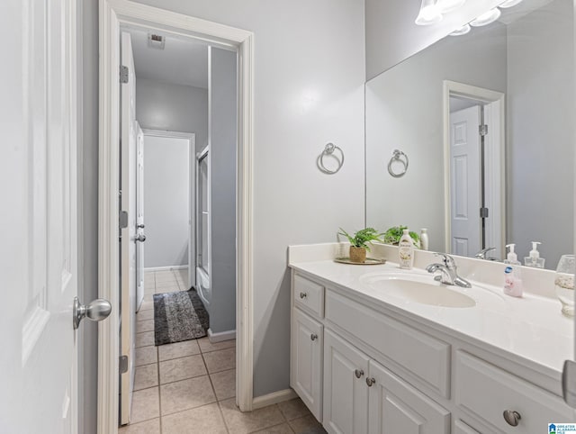 bathroom with tile patterned flooring, vanity, and a shower with door