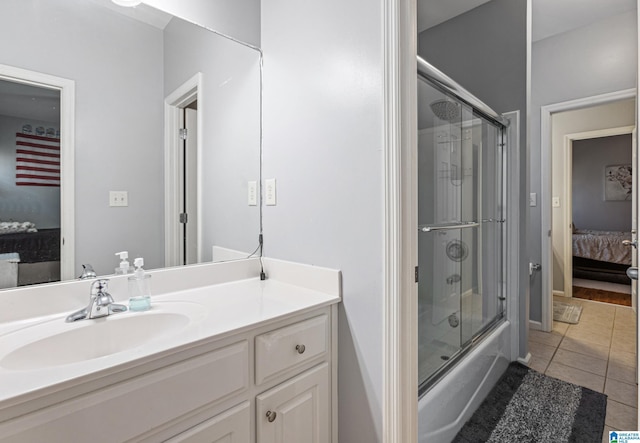 bathroom with tile patterned flooring, vanity, and shower / bath combination with glass door