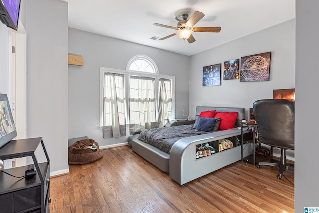 bedroom featuring hardwood / wood-style flooring and ceiling fan