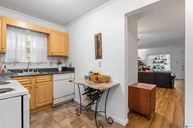 kitchen featuring light brown cabinets, white appliances, sink, ornamental molding, and a textured ceiling