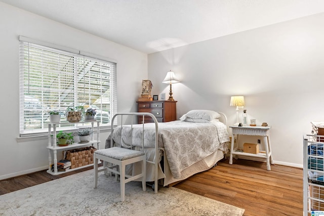 bedroom with hardwood / wood-style floors