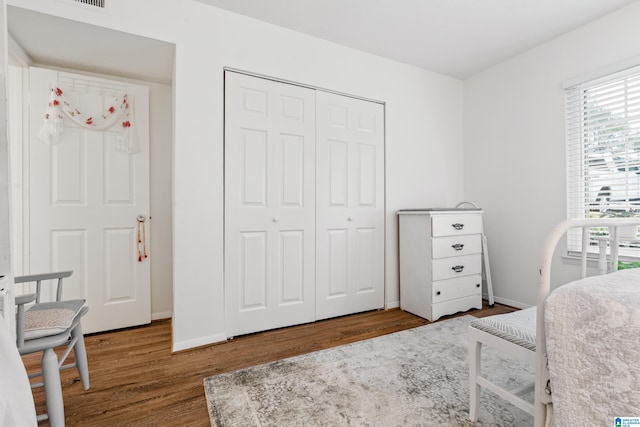 bedroom featuring hardwood / wood-style flooring and a closet