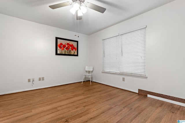 unfurnished room with ceiling fan and light wood-type flooring