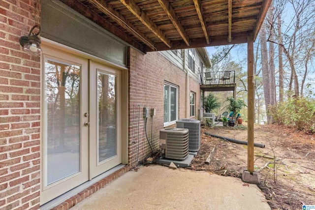 doorway to property with central AC and a patio area