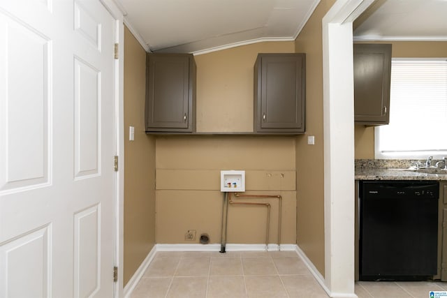 washroom with washer hookup, light tile patterned floors, and ornamental molding