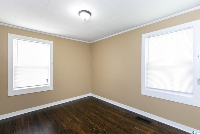 spare room with crown molding and dark hardwood / wood-style flooring