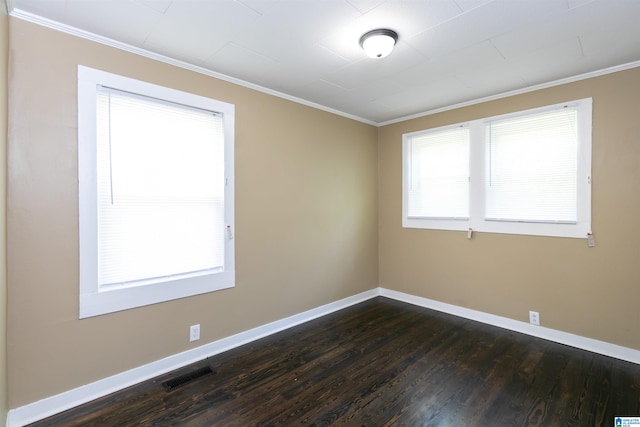 spare room with ornamental molding and dark wood-type flooring