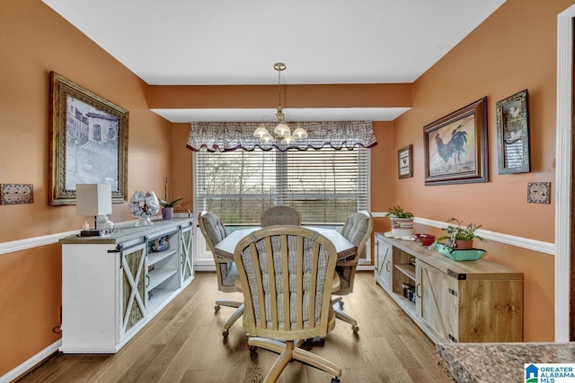 dining area with a chandelier and light hardwood / wood-style floors