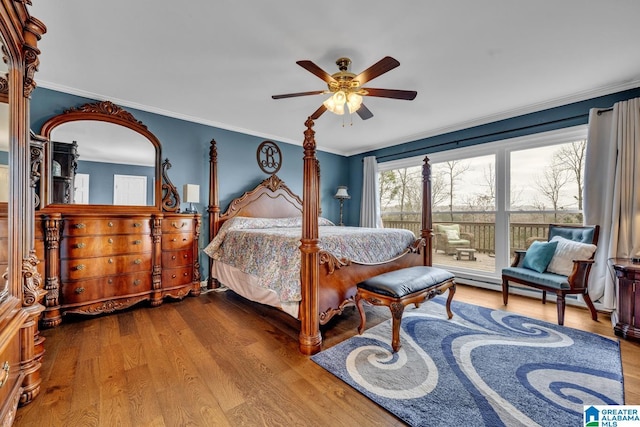 bedroom featuring ceiling fan, ornamental molding, and hardwood / wood-style flooring