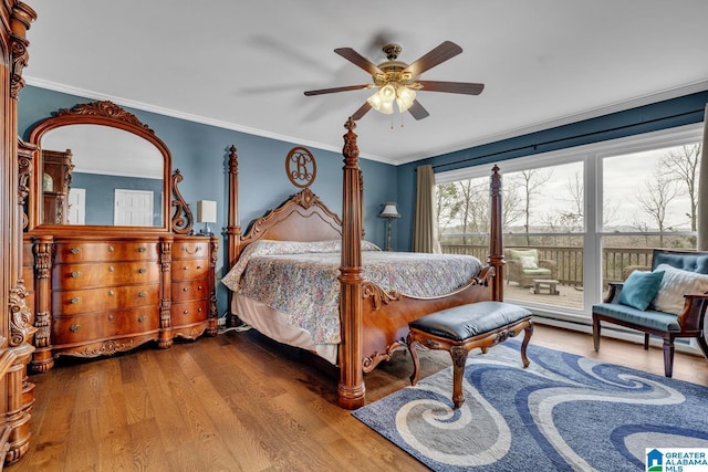 bedroom with wood-type flooring, ceiling fan, and ornamental molding