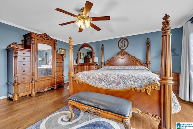 bedroom featuring hardwood / wood-style flooring, ceiling fan, and crown molding