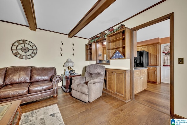 living room featuring beamed ceiling and light hardwood / wood-style flooring