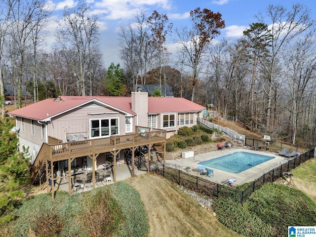 back of property with a deck and a patio area