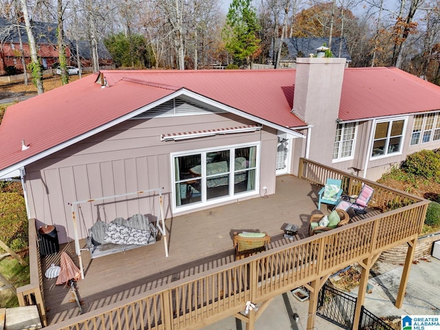 rear view of property with a wooden deck