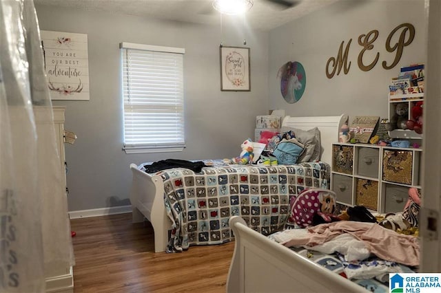 bedroom with hardwood / wood-style flooring and ceiling fan