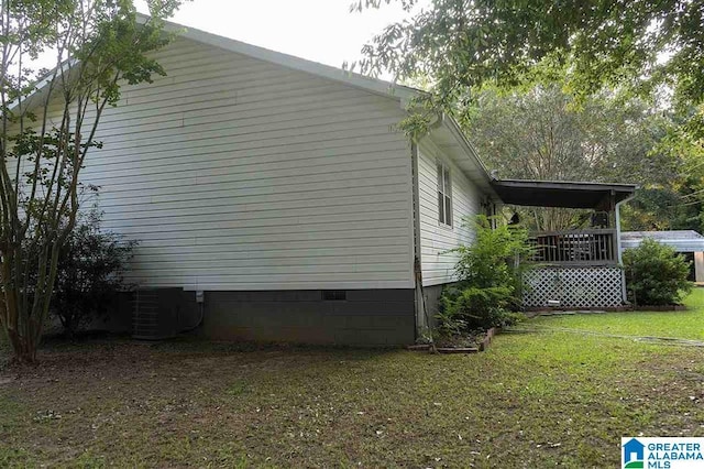 view of home's exterior with a lawn, a wooden deck, and cooling unit