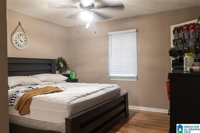 bedroom with ceiling fan and wood-type flooring