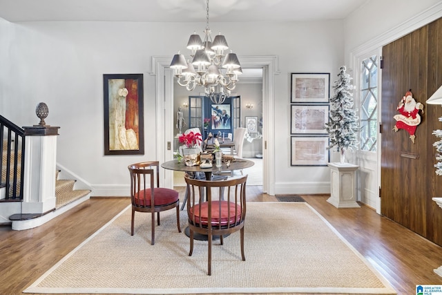 dining room with light hardwood / wood-style flooring and an inviting chandelier