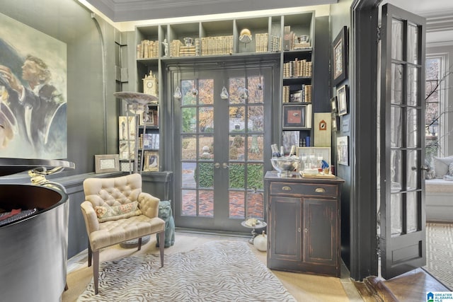 sitting room featuring a wealth of natural light, french doors, and crown molding