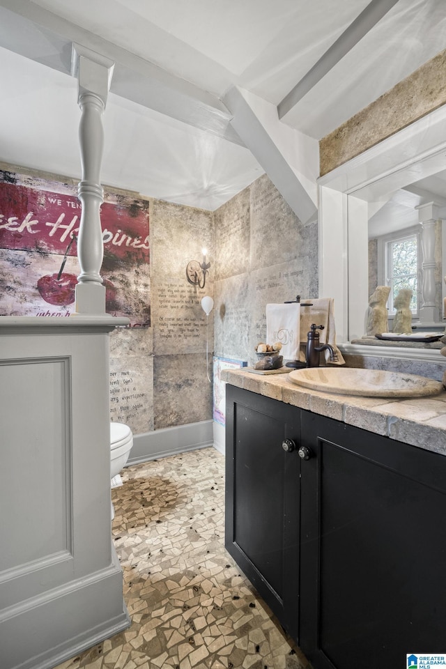 bathroom featuring vanity and toilet