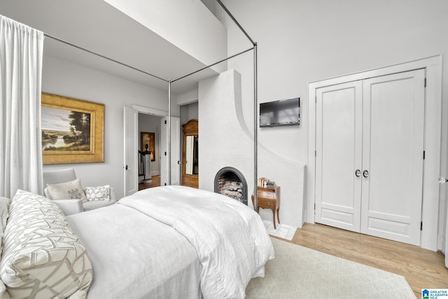 bedroom with light wood-type flooring and a closet