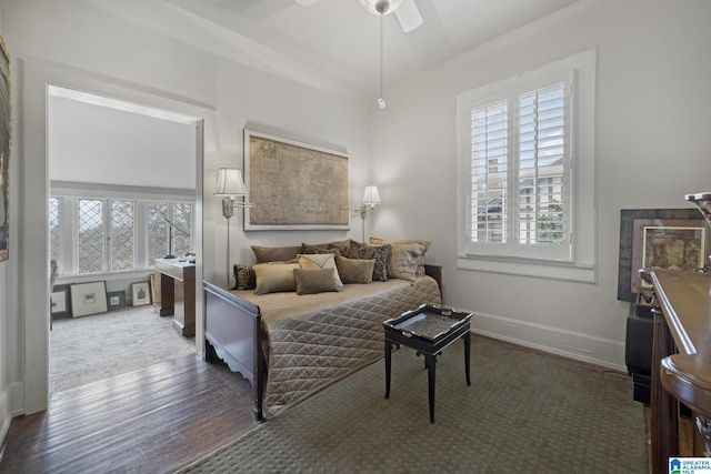 bedroom featuring multiple windows, ceiling fan, and hardwood / wood-style flooring