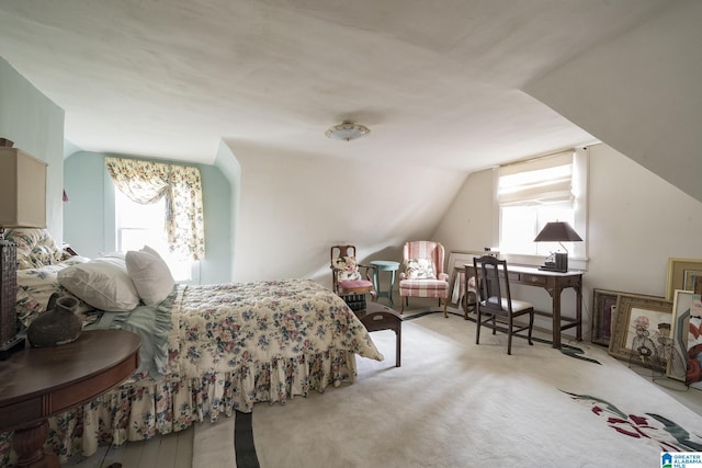 carpeted bedroom with vaulted ceiling