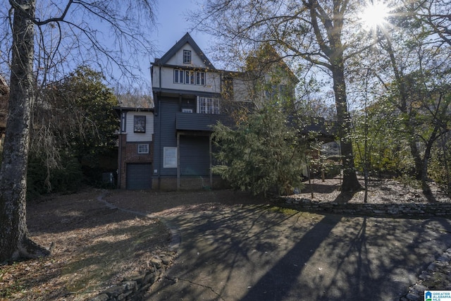 rear view of house with a balcony and a garage