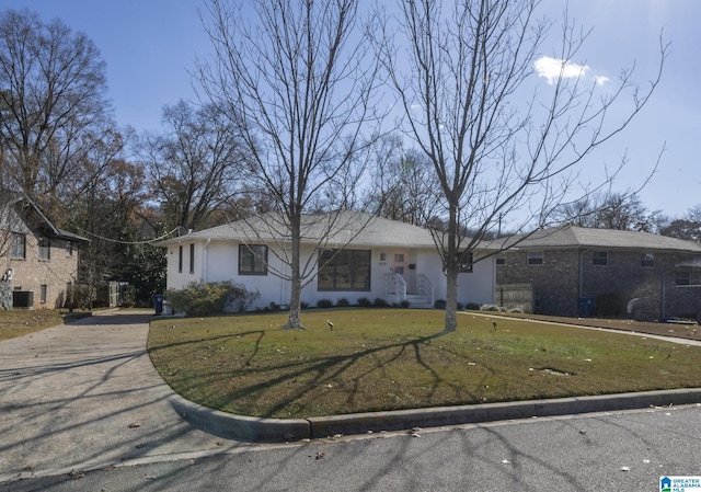 ranch-style home featuring a front yard and central AC