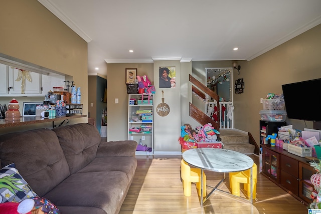 living room featuring light hardwood / wood-style floors and ornamental molding