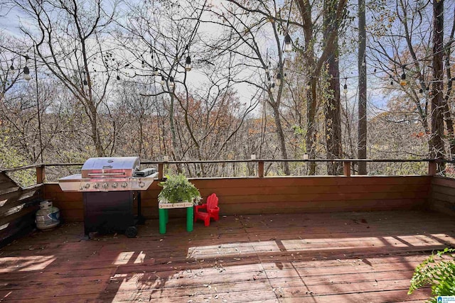 wooden terrace with a grill