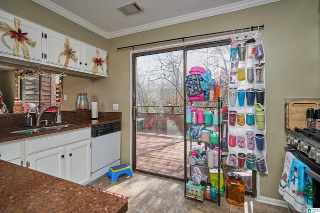 kitchen featuring white dishwasher, crown molding, sink, dark stone countertops, and white cabinets