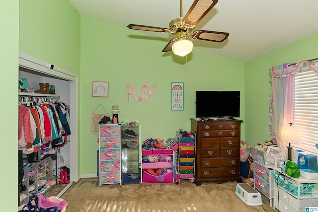 carpeted bedroom with a closet, ceiling fan, and lofted ceiling