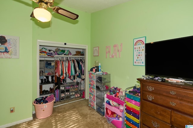 bedroom with carpet flooring, ceiling fan, and a closet