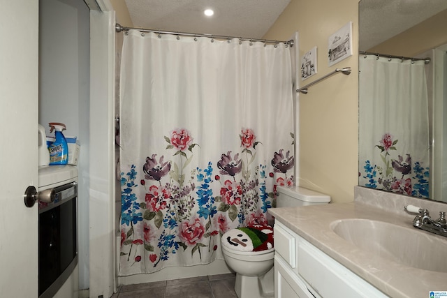 full bathroom featuring shower / bath combo, tile patterned flooring, a textured ceiling, toilet, and vanity