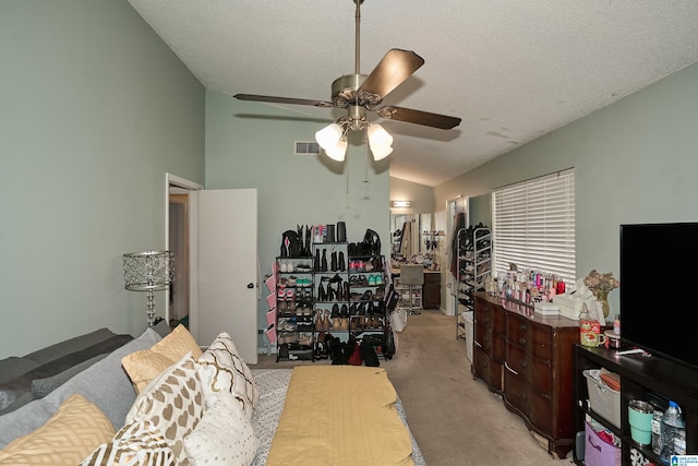 bedroom with a textured ceiling, light colored carpet, ceiling fan, and lofted ceiling