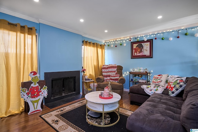 living room with hardwood / wood-style flooring and ornamental molding