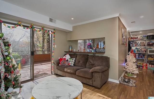 living room with light hardwood / wood-style floors and ornamental molding